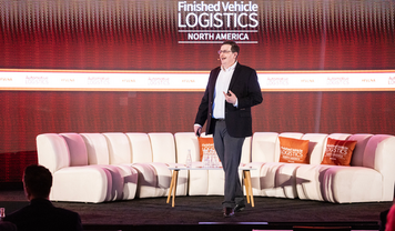 NADA's chief economist on stage at Finished Vehicle Logistics North America 2026 conference.